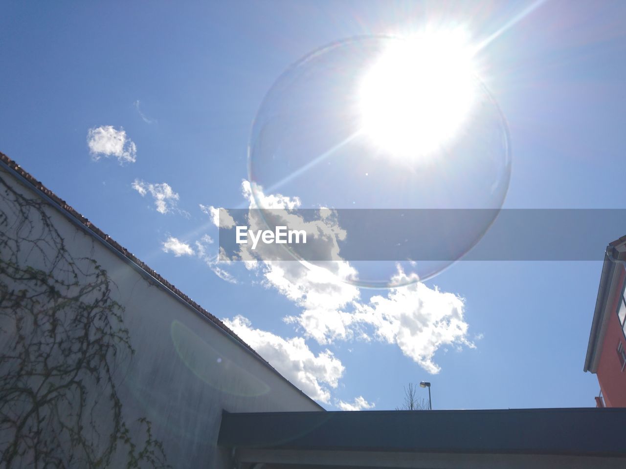 Low angle view of buildings against sky on sunny day