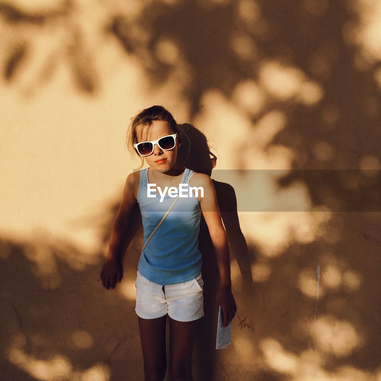 Full length of girl wearing sunglasses standing outdoors