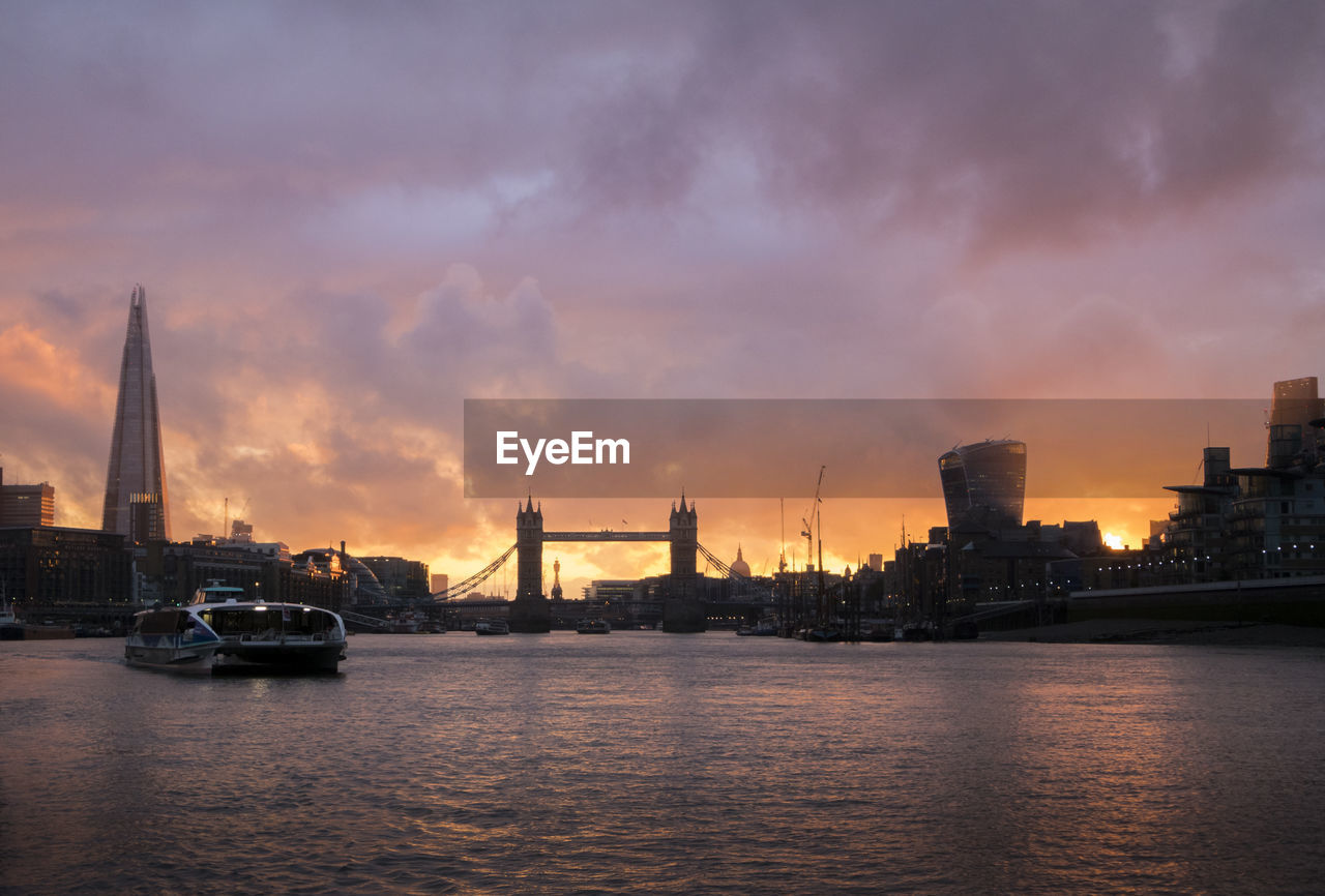 Sunset over tower bridge and the shard in london, uk, taken from the river thames