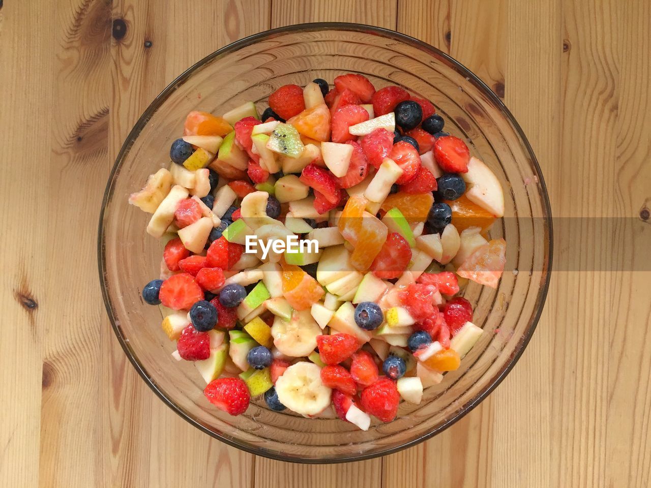 CLOSE-UP OF FRUITS IN BOWL ON WOODEN TABLE