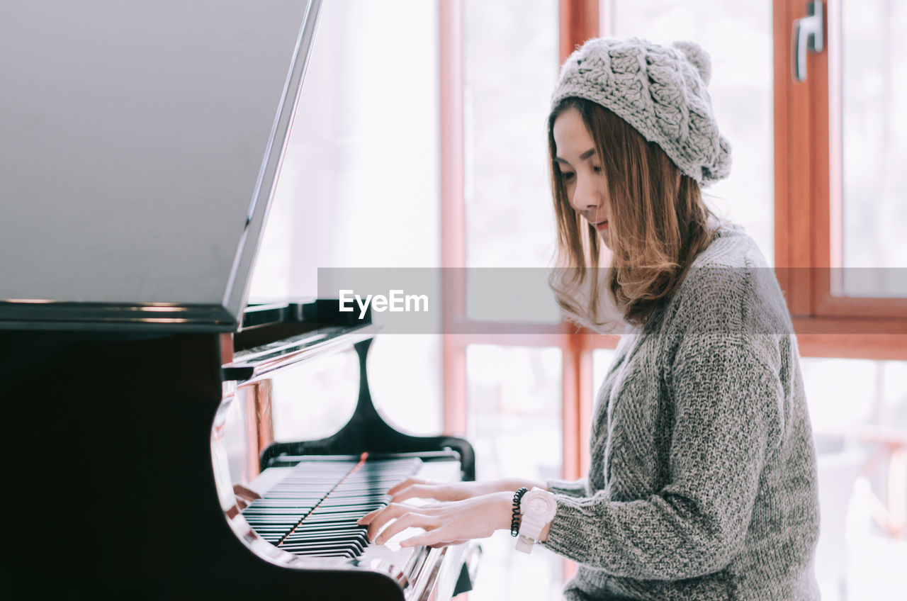 Beautiful woman playing piano