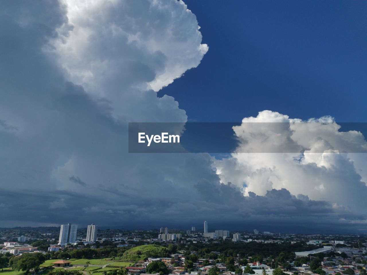 Aerial view of big cloud on city against sky