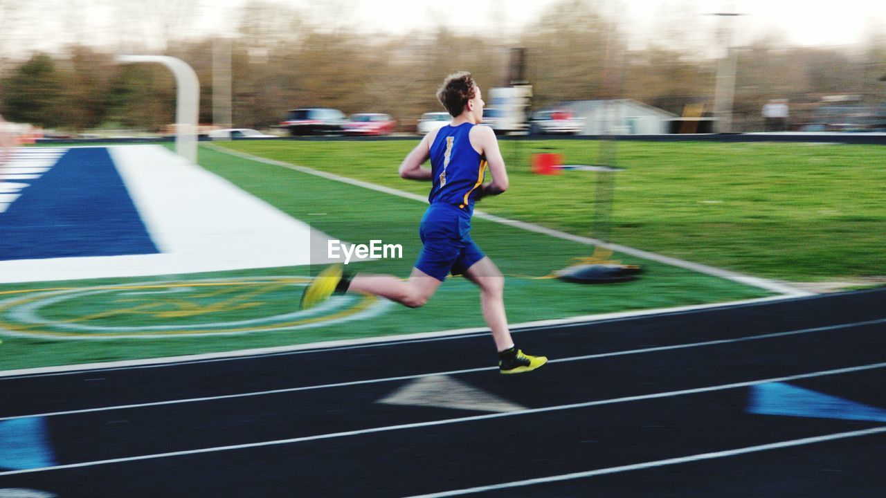 Full length of man running on track