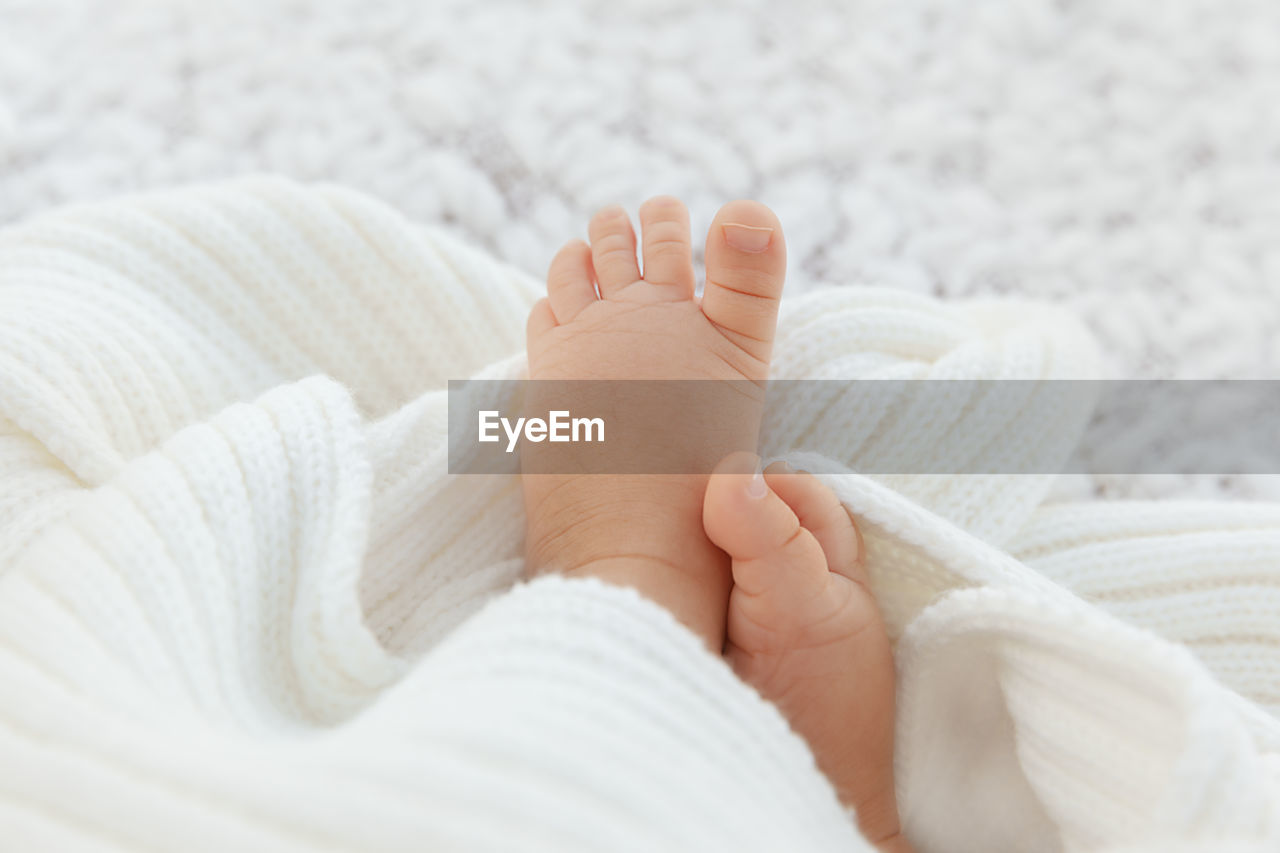 LOW SECTION OF BABY FEET