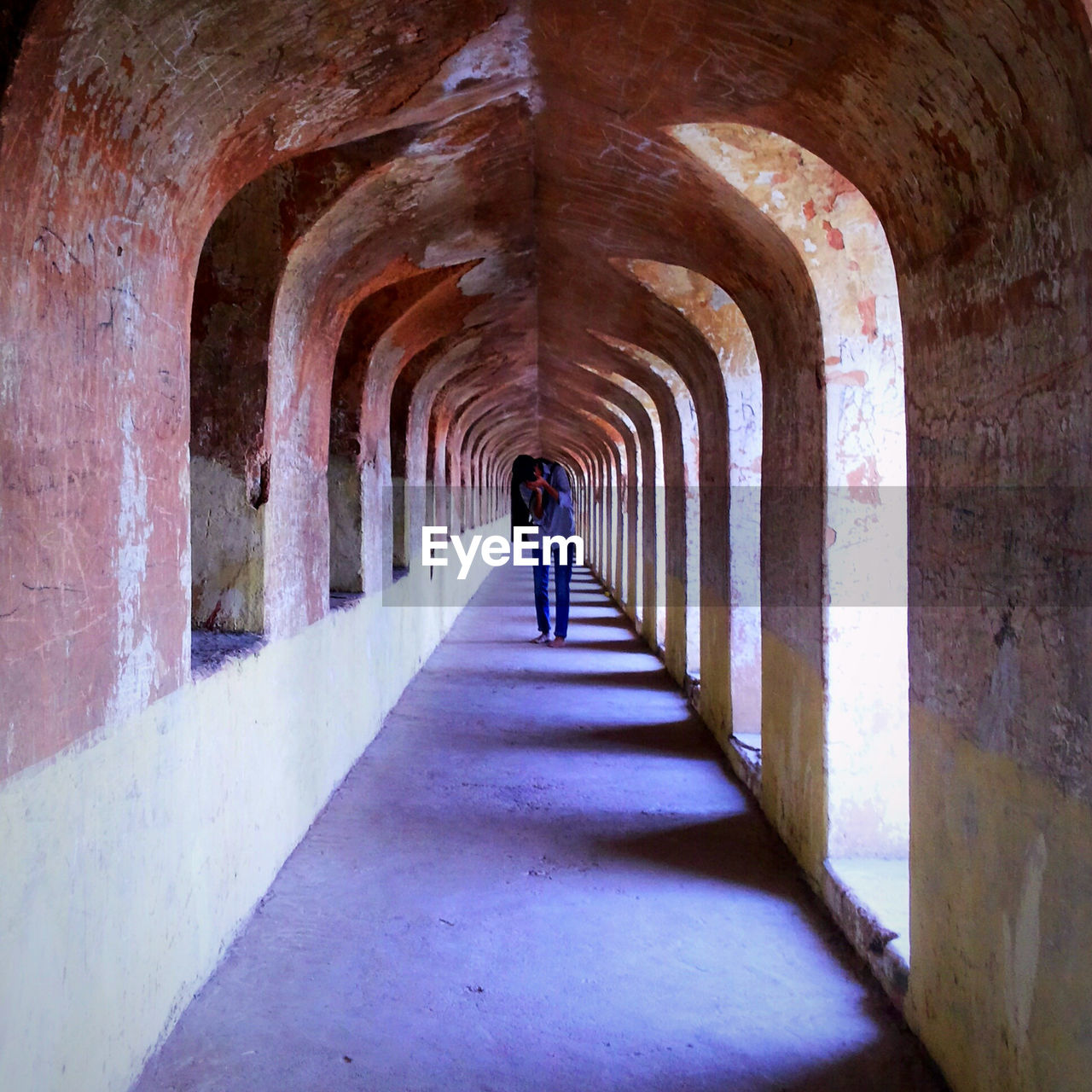 WOMAN WALKING IN CORRIDOR