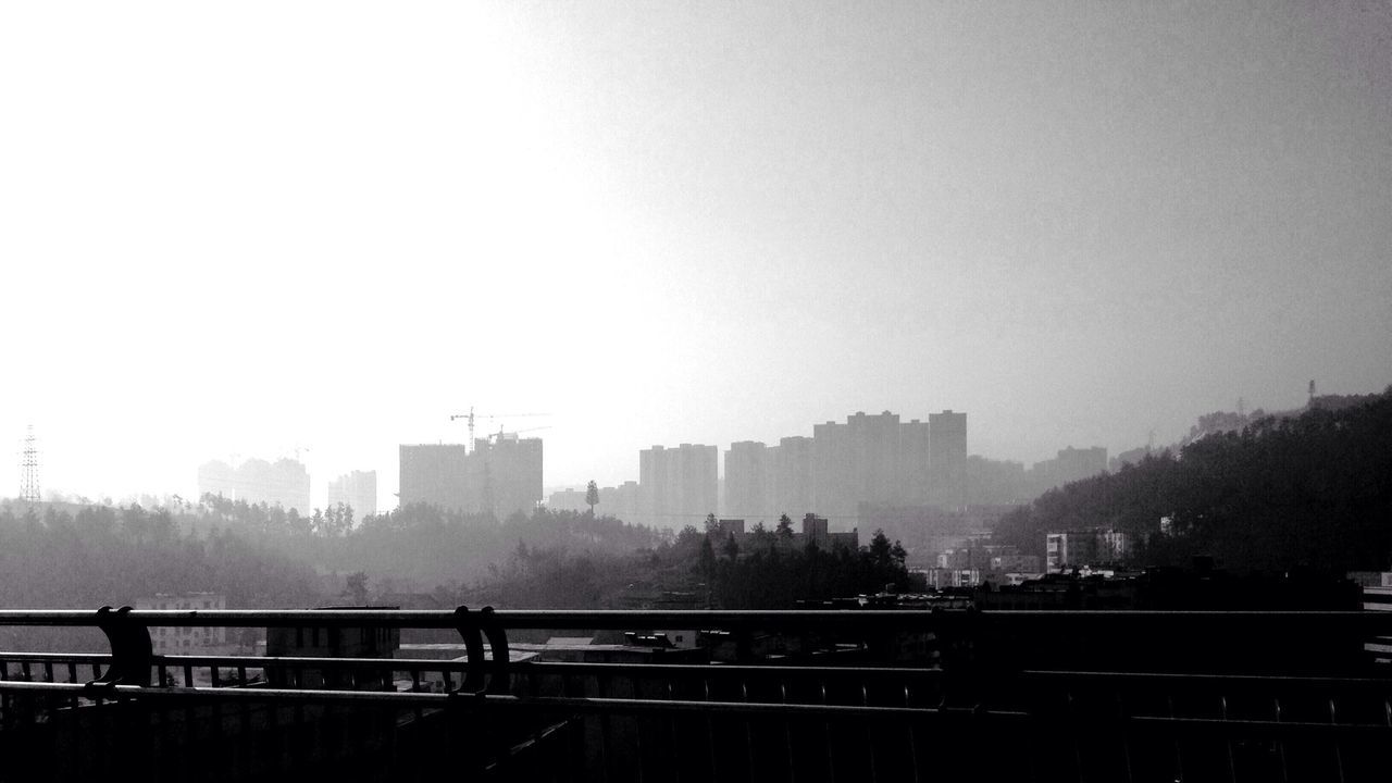 City skyline in foggy weather seen from bridge