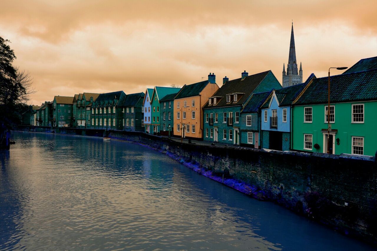 VIEW OF RIVER WITH BUILDINGS IN BACKGROUND