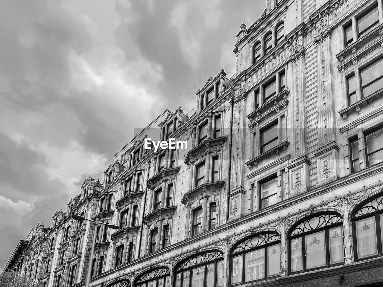 Low angle view of building against cloudy sky