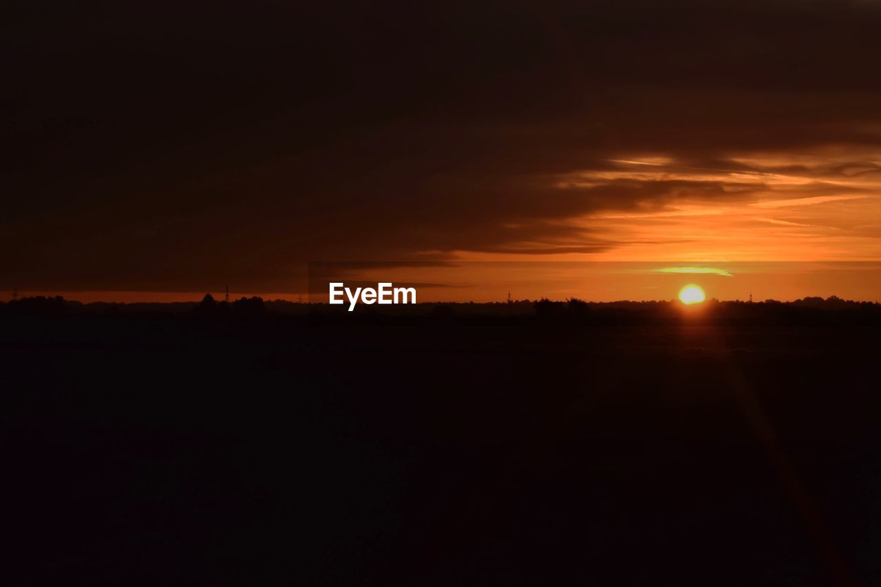 SILHOUETTE OF LANDSCAPE AT SUNSET