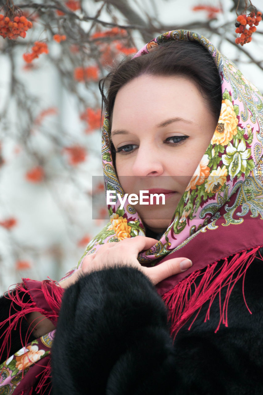 Close-up of woman wearing scarf at park