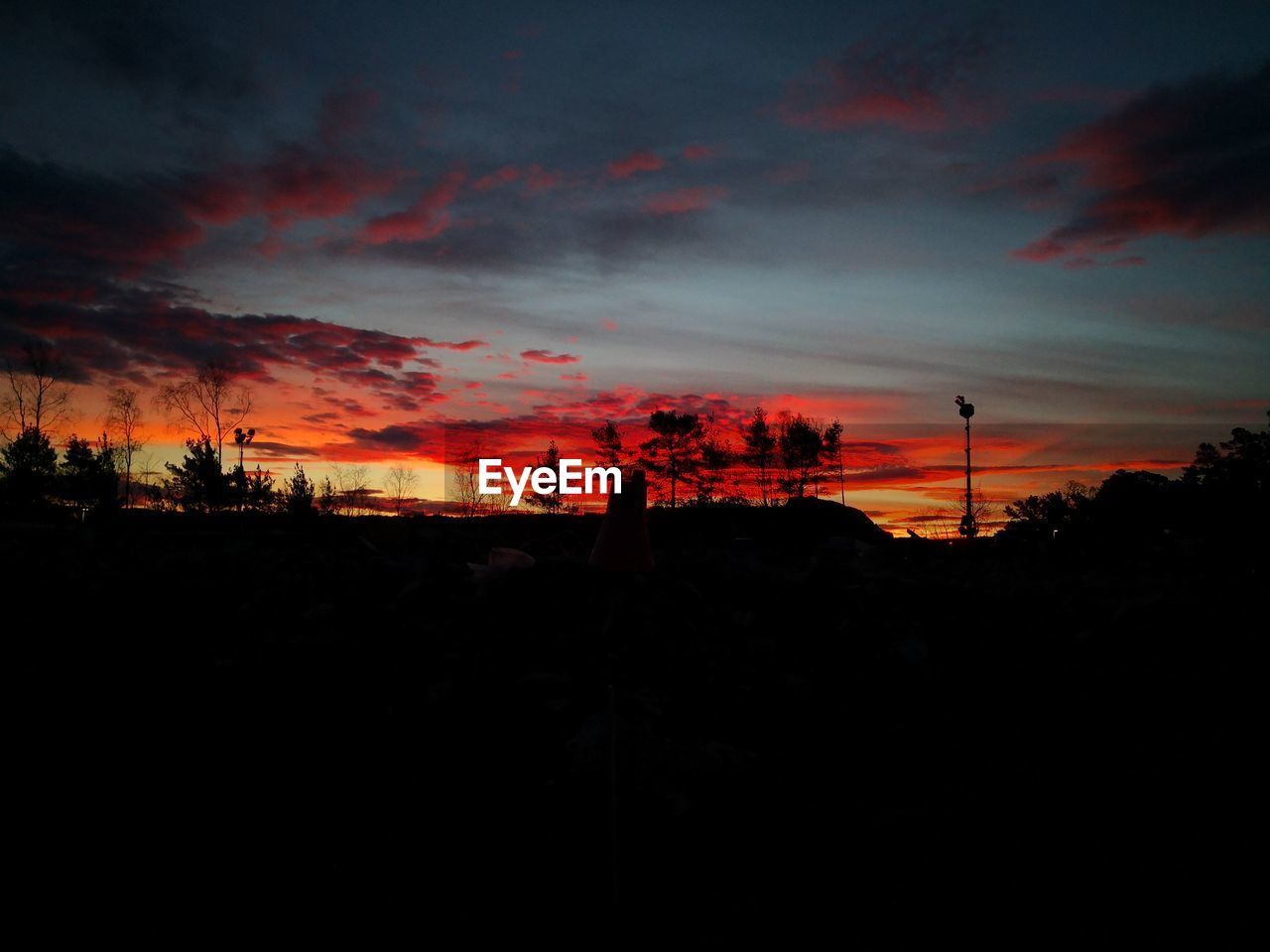 SCENIC VIEW OF SILHOUETTE LANDSCAPE AGAINST DRAMATIC SKY