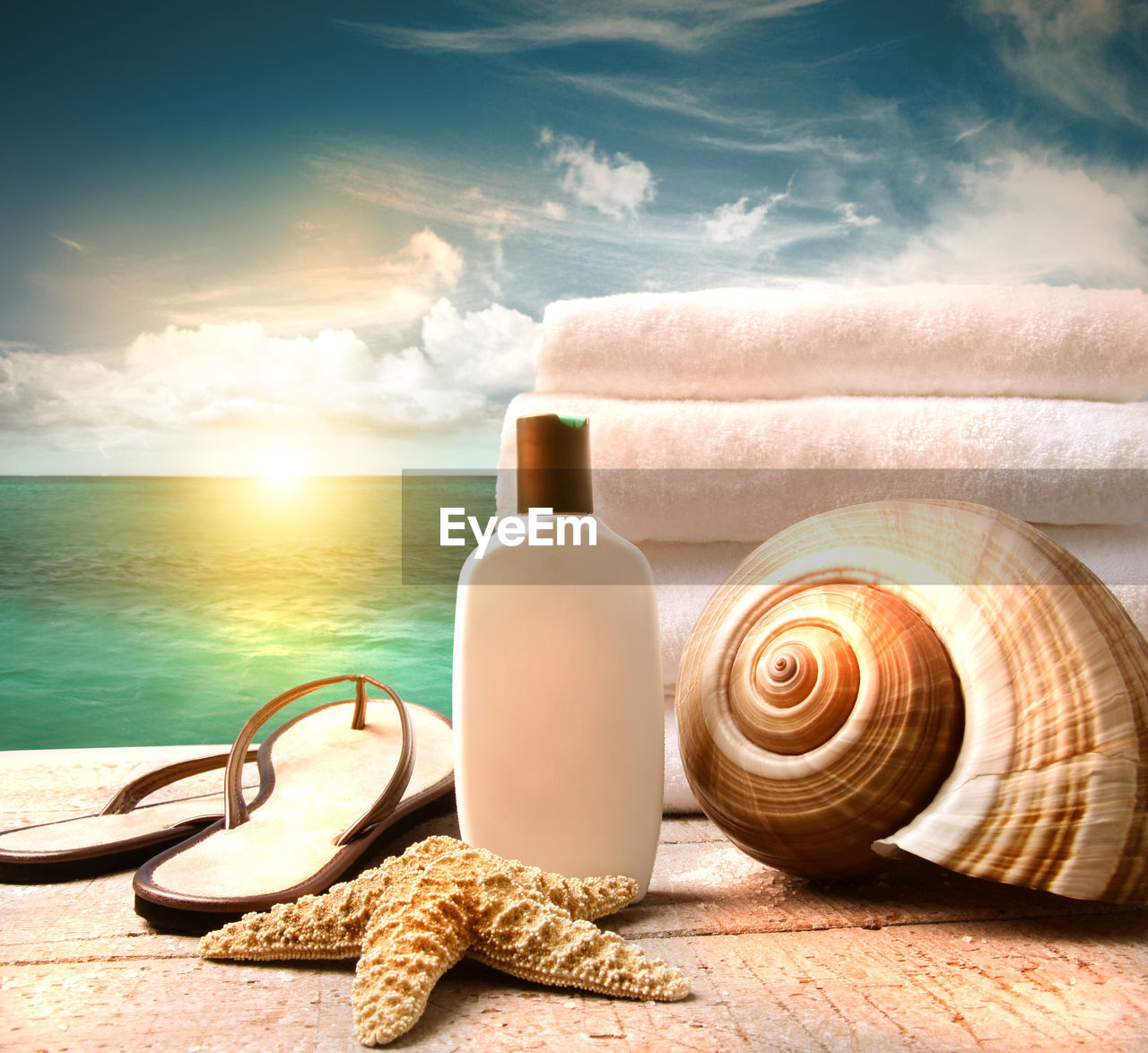 sea, nature, sky, water, land, beach, beauty in nature, shell, cloud, tranquil scene, sunlight, bottle, summer, snail, sand, tranquility, no people, animal, idyllic, animal shell, vacation, holiday, outdoors, trip, wood, sun, travel, still life photography, copy space