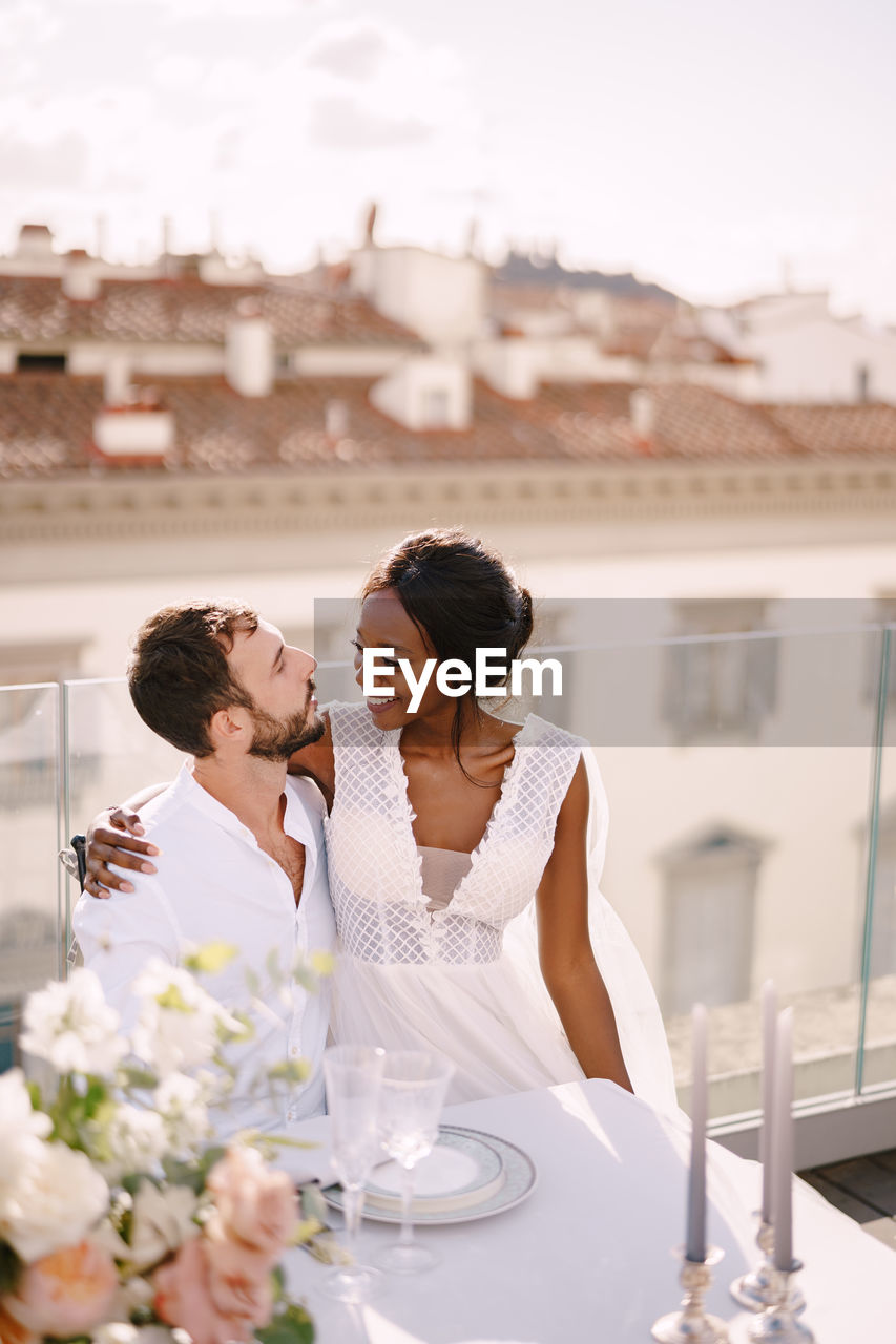 COUPLE SITTING ON TABLE