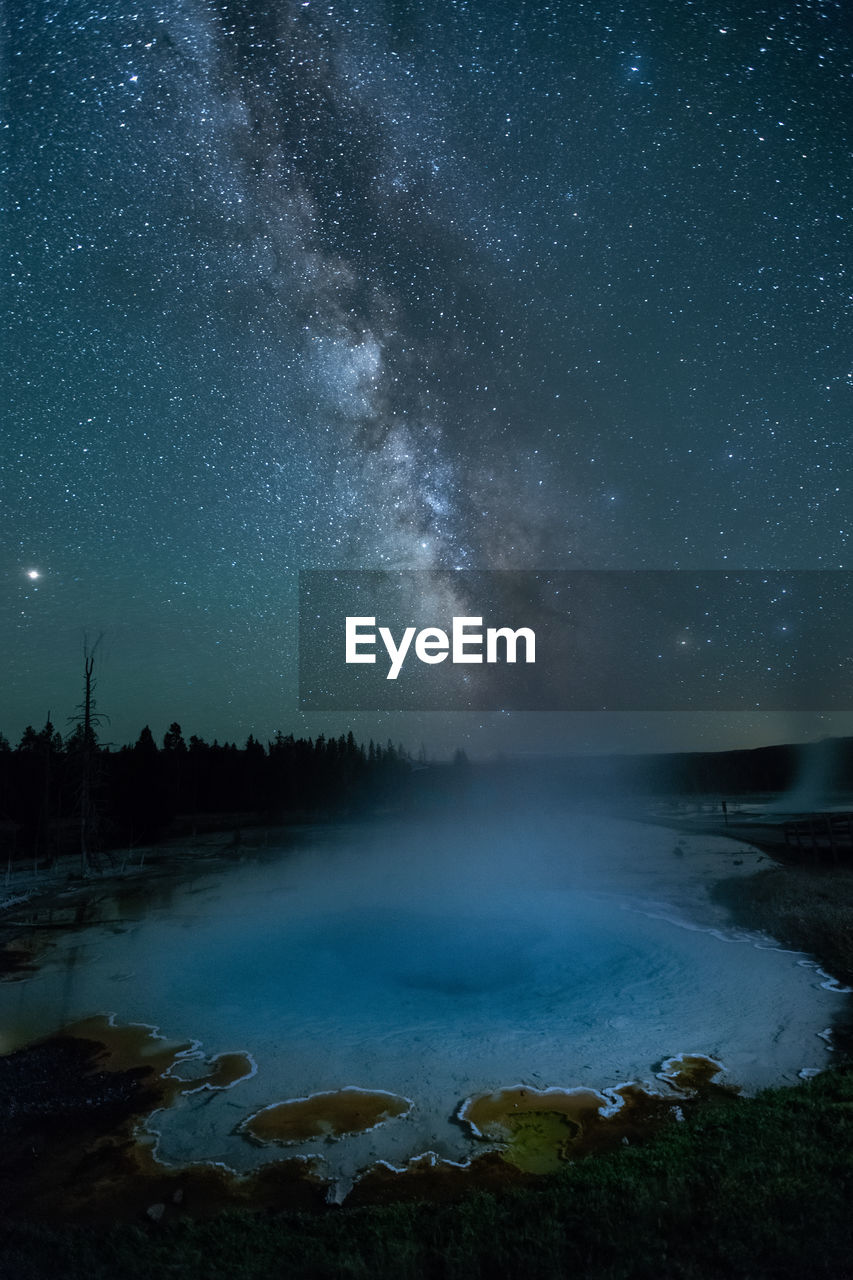 Scenic view of lake against sky at night