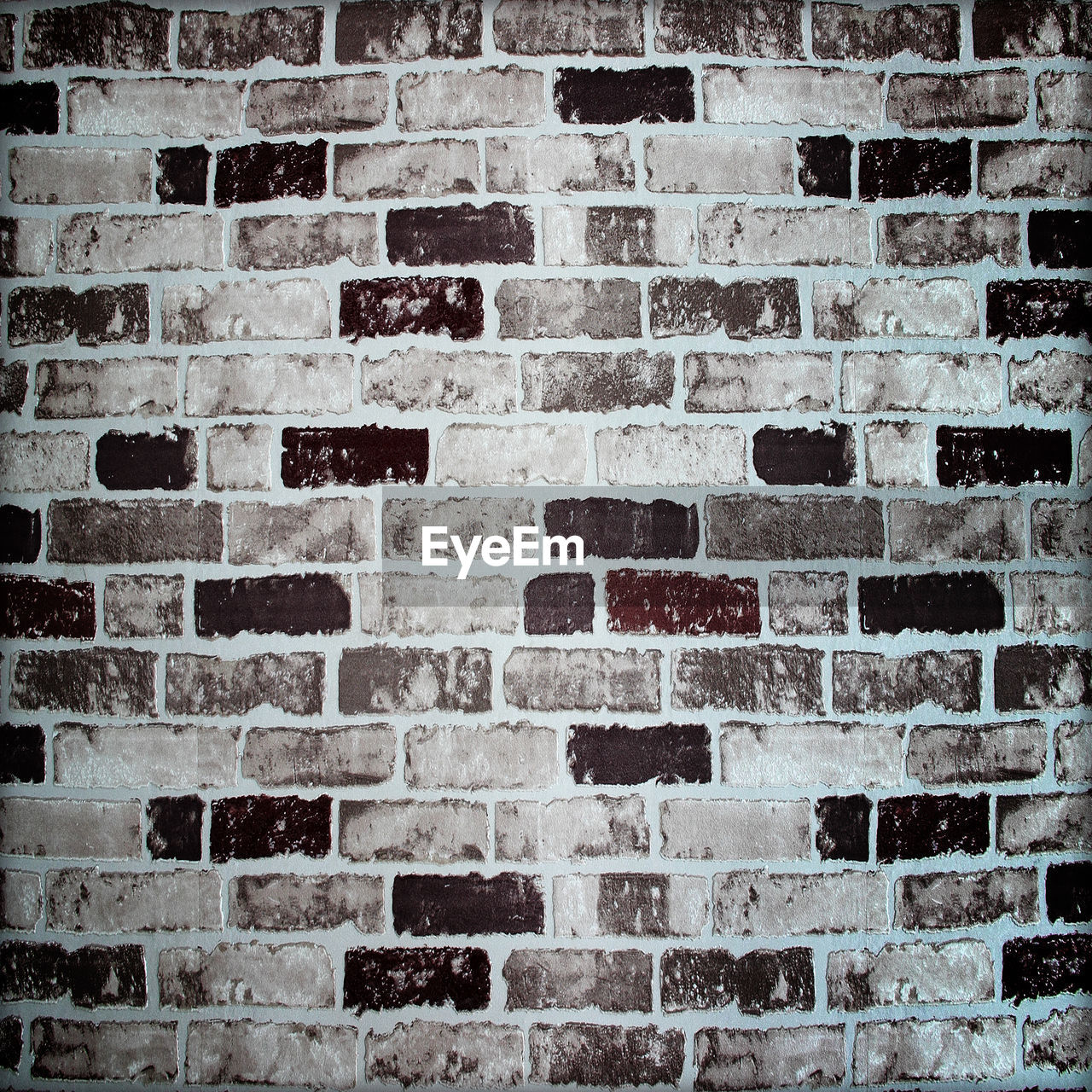 FULL FRAME SHOT OF BRICK WALL WITH BUILDING