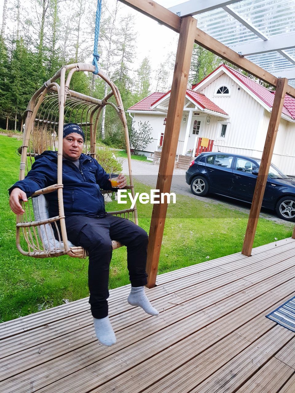 FULL LENGTH PORTRAIT OF MAN SITTING ON PLANT