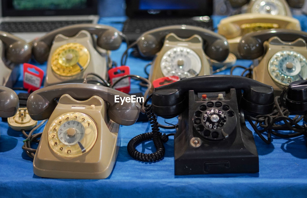 Close-up of old telephones on table