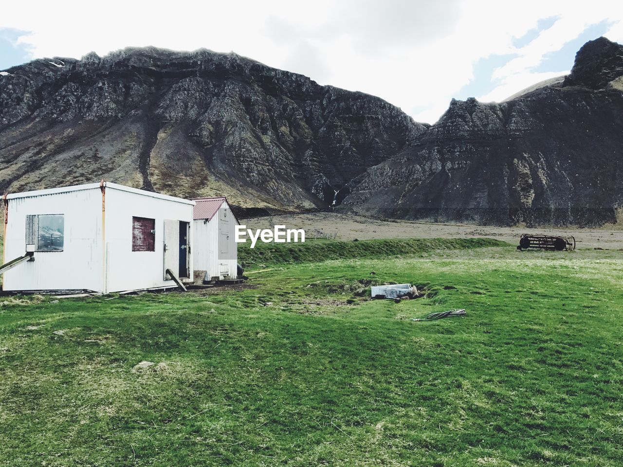 Scenic view of field and mountain against sky