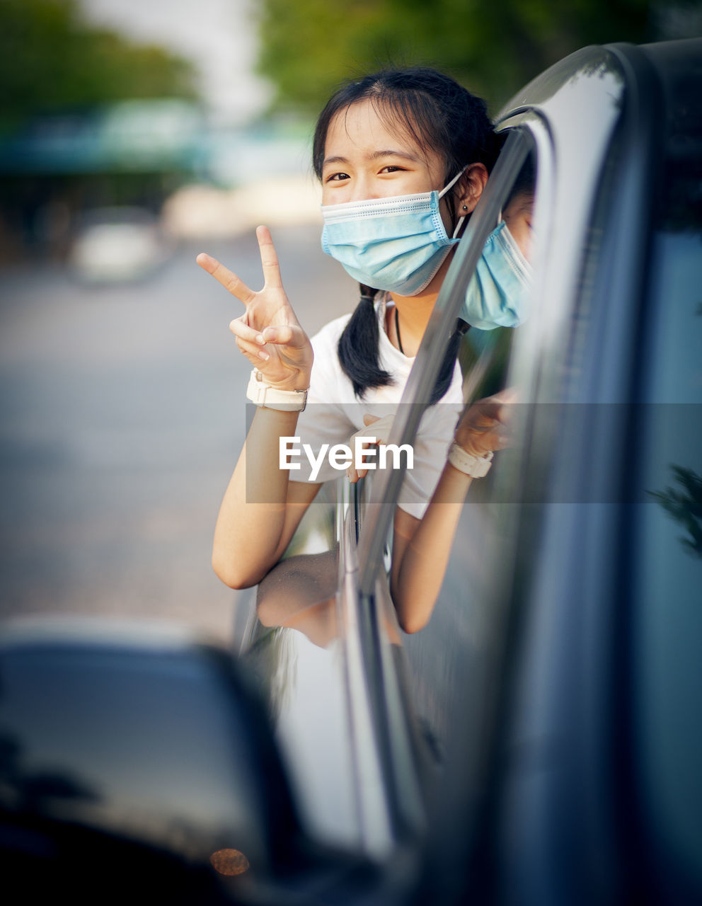 Portrait of young woman in car