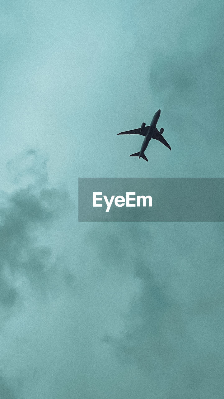 flying, air vehicle, airplane, sky, mode of transportation, transportation, cloud, low angle view, no people, nature, travel, mid-air, on the move, vehicle, motion, aircraft, aviation, blue, outdoors, day, journey, wing, air force