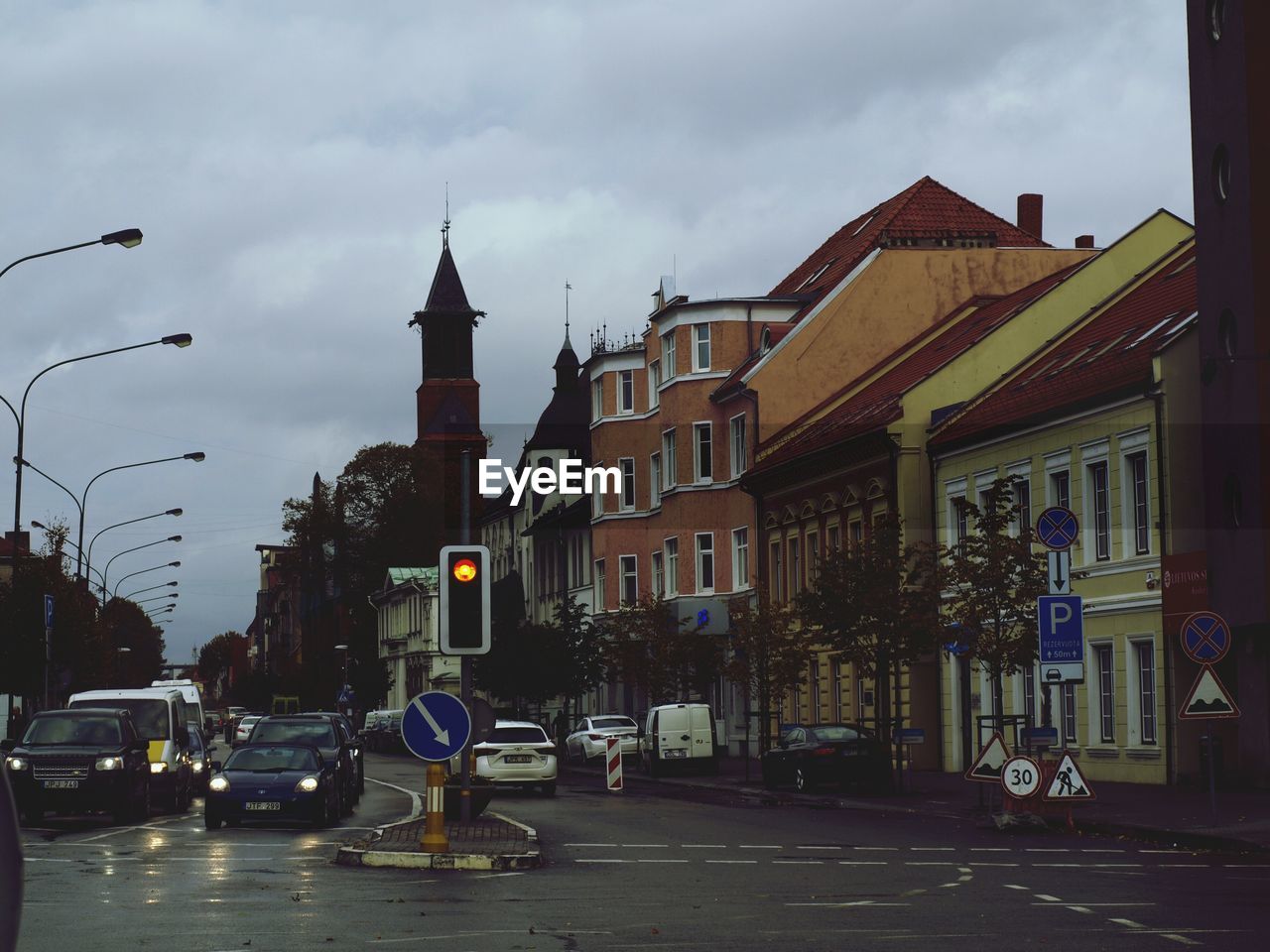 Cars on road against buildings in city