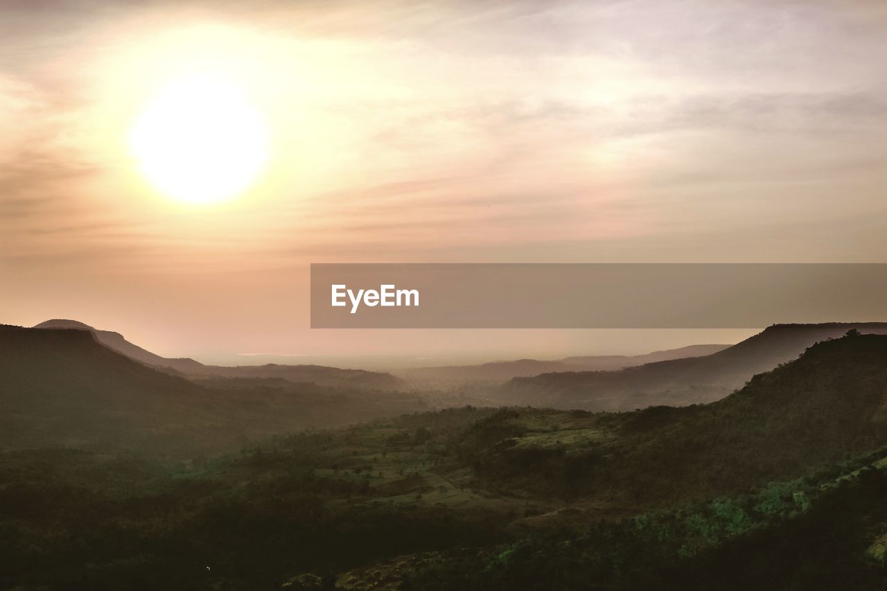 Scenic view of landscape against sky during sunset