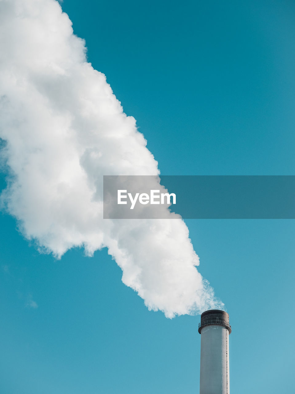 Low angle view of smoke stack against sky