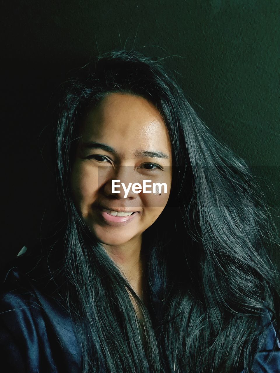 PORTRAIT OF A SMILING YOUNG WOMAN WITH EYES CLOSED