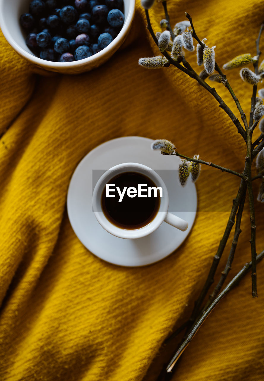 DIRECTLY ABOVE SHOT OF COFFEE CUP ON TABLE AT HOME