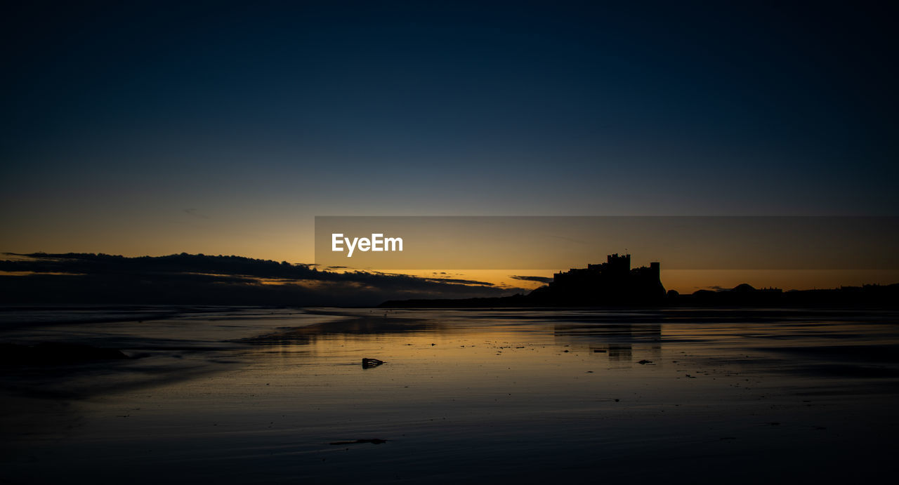 SILHOUETTE BEACH AGAINST SKY DURING SUNSET