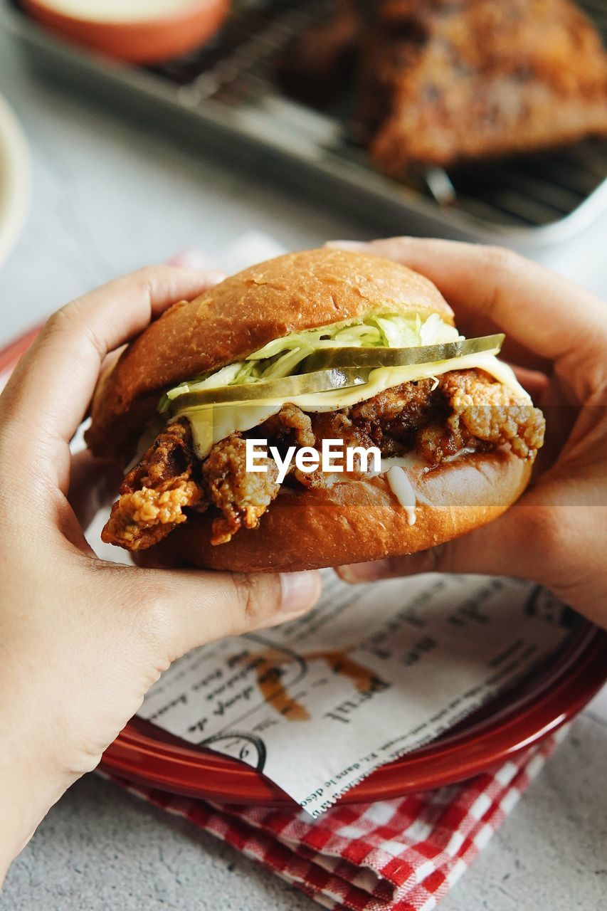 Close-up of hand holding burger