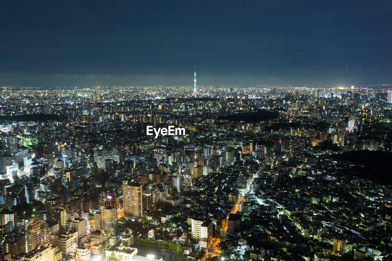 Aerial view of city lit up at night