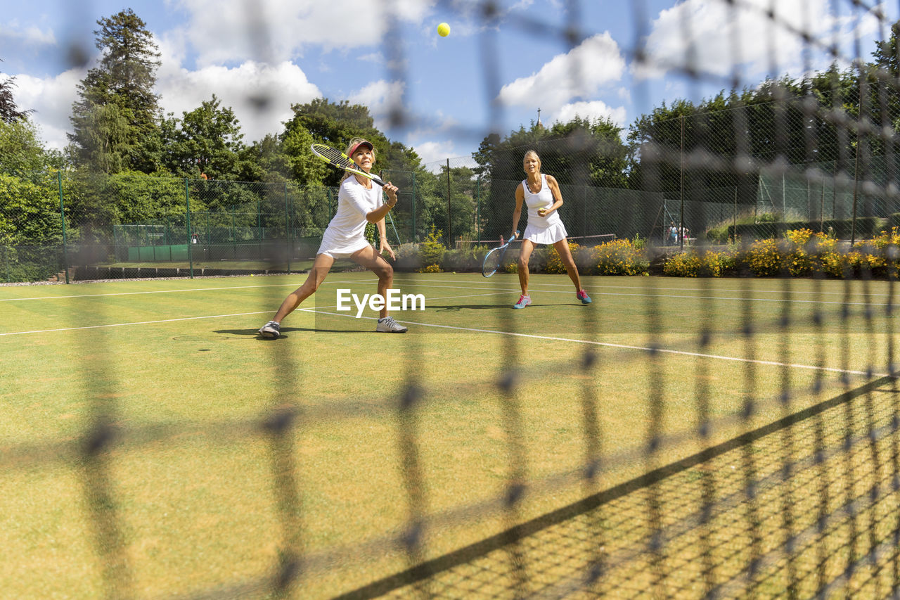 Mature women during a tennis match on grass court