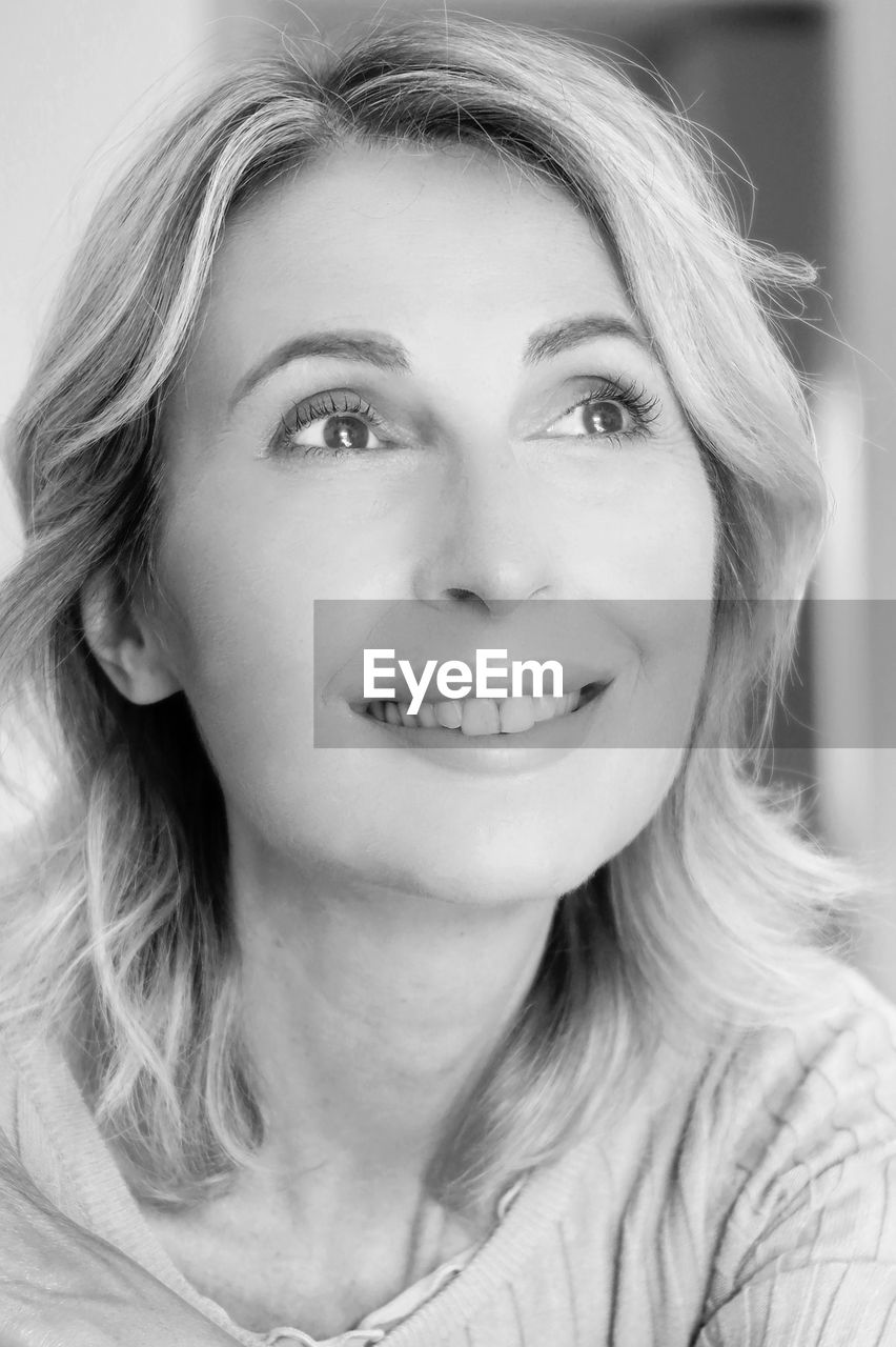 portrait, black and white, one person, human face, women, headshot, smiling, portrait photography, adult, monochrome photography, looking at camera, monochrome, happiness, emotion, front view, white, blond hair, long hair, hairstyle, person, indoors, young adult, close-up, human head, female, human hair, cheerful, lifestyles, nose, eyebrow, smile, teeth, casual clothing
