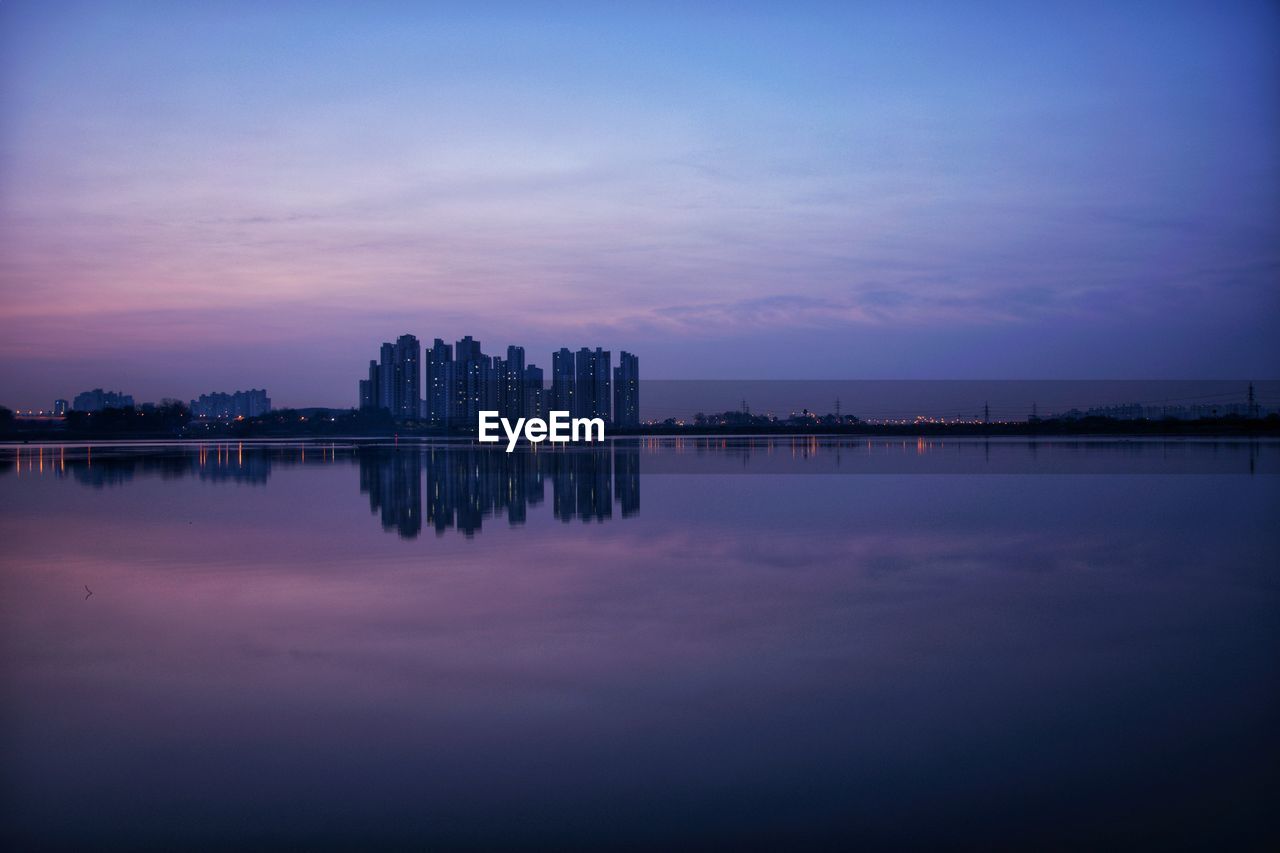 Scenic view of lake against sky at dawn