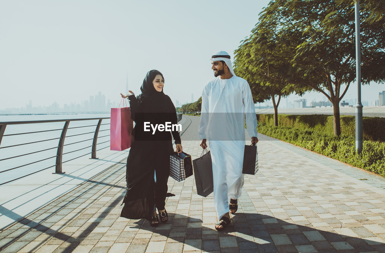 COUPLE WALKING ON FOOTPATH BY PEOPLE