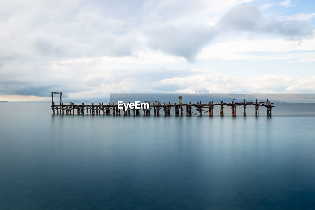 Pier over sea against sky