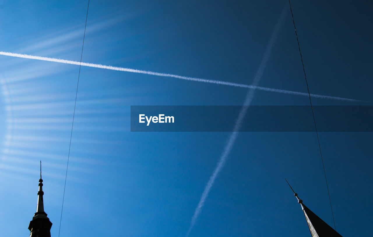 LOW ANGLE VIEW OF VAPOR TRAILS AGAINST SKY