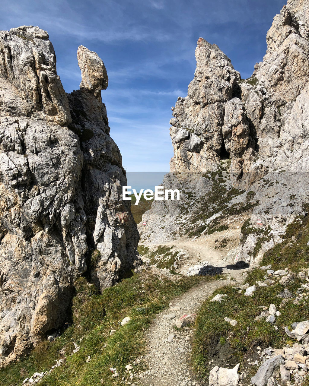 LOW ANGLE VIEW OF ROCK FORMATION AMIDST LAND AGAINST SKY