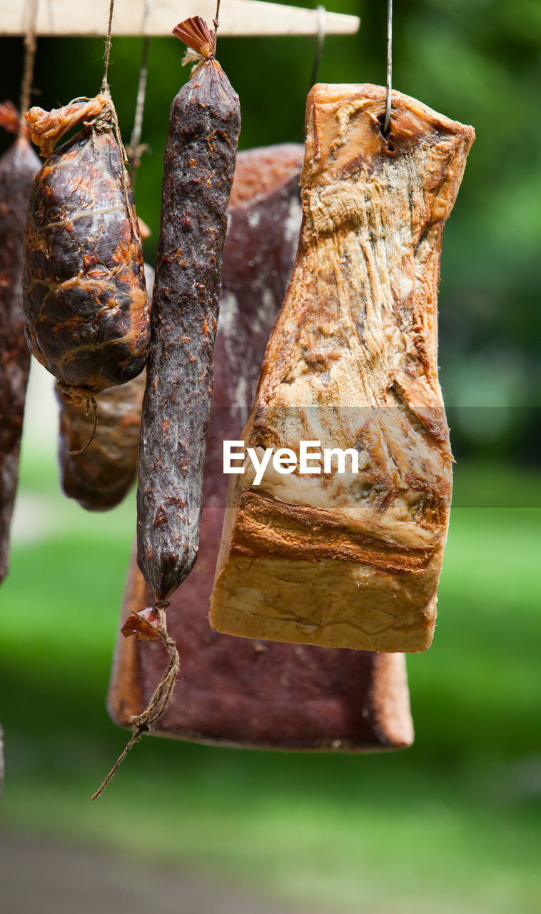 Close-up of smoked bacon hanging outdoors