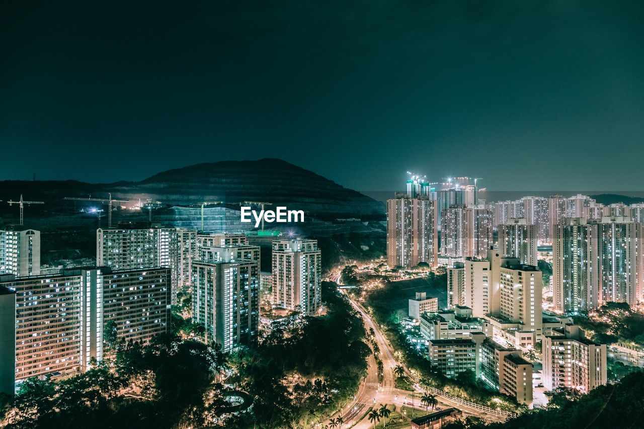 High angle view of city lit up at night