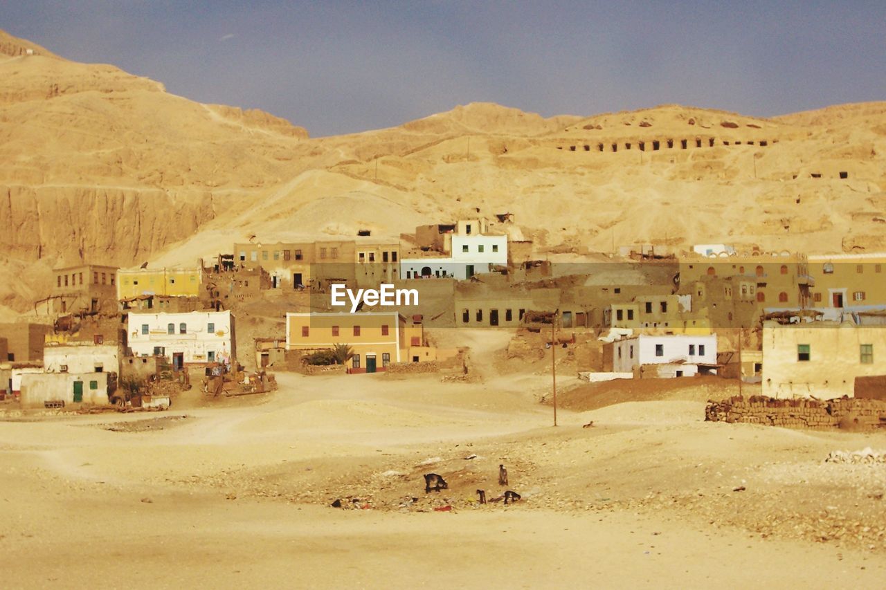 BUILDINGS IN TOWN AGAINST MOUNTAINS