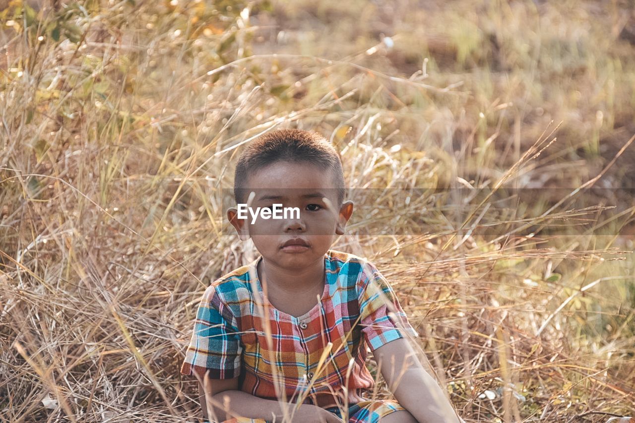 Portrait of boy on field