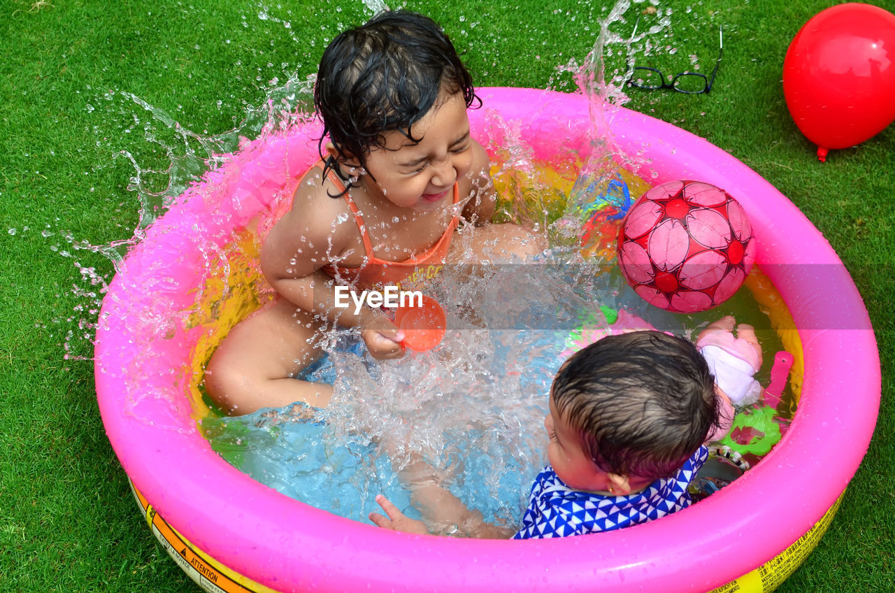 Happy children playing in swimming pool