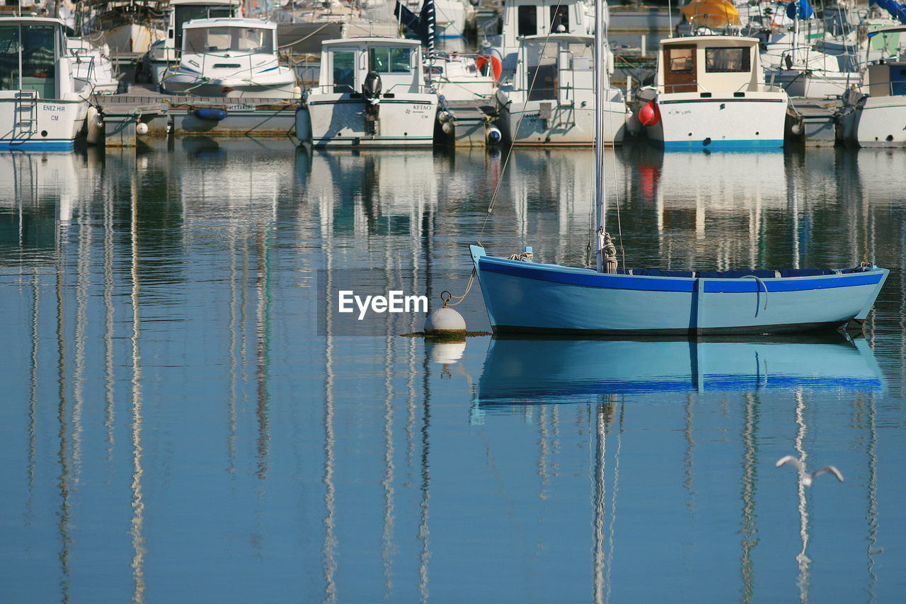 Boats moored at harbor