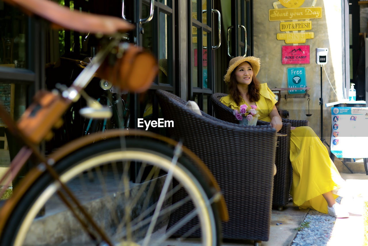 Rear view of man riding bicycle on street