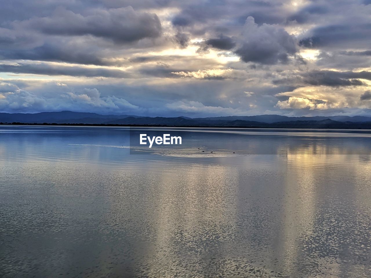 VIEW OF SEA AGAINST CLOUDY SKY