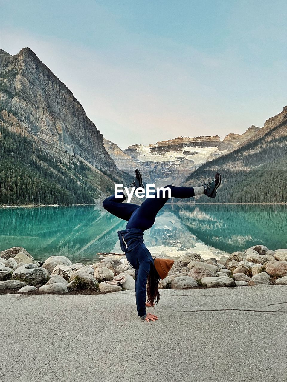 side view of man standing on rock against mountain