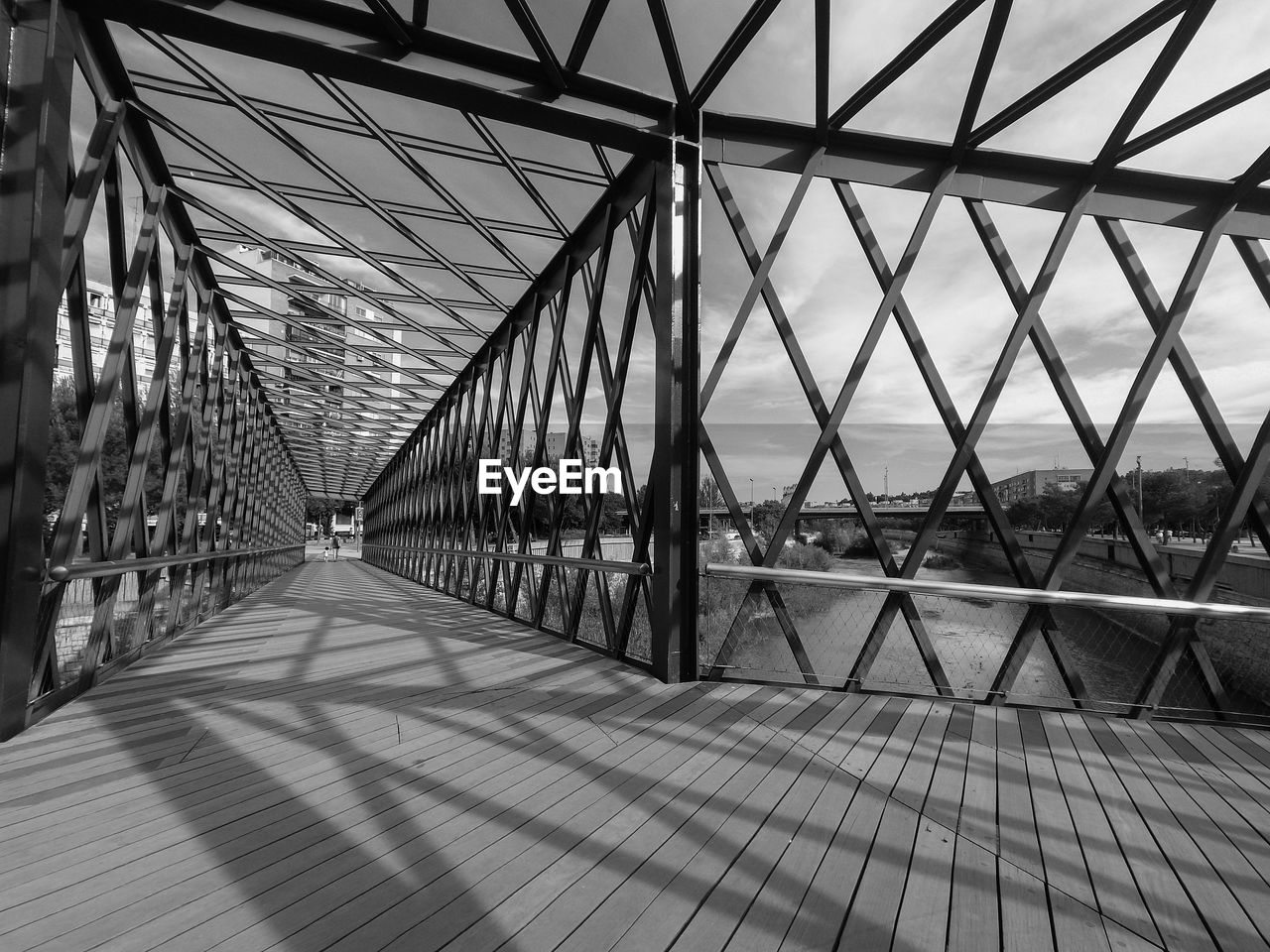 VIEW OF SUSPENSION BRIDGE AGAINST CLOUDY SKY