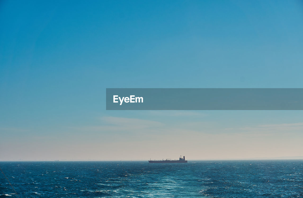 BOAT IN SEA AGAINST SKY